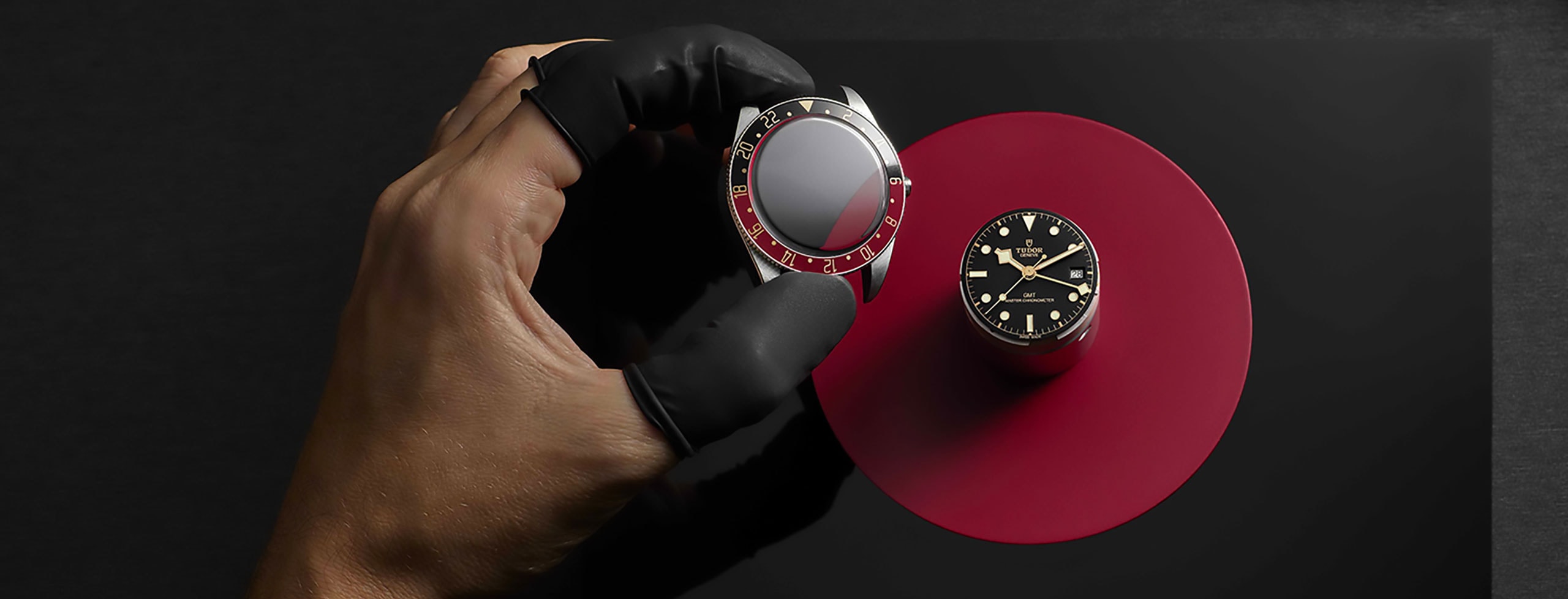 Tudor watch case and red bezel being assembled - Lucerne Watches